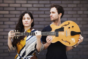 Portrait of Yumi Ito and Szymon Mika handled a guitar